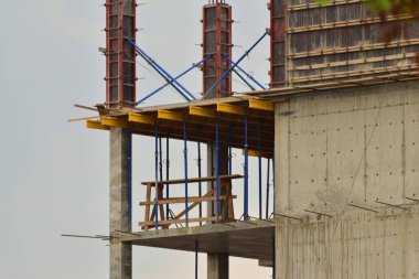  Kuzey Kafkasya 'nın eteklerinde gökyüzüne karşı tuğla ve iskelesi olan çok katlı bir bina inşa ediliyor.                              