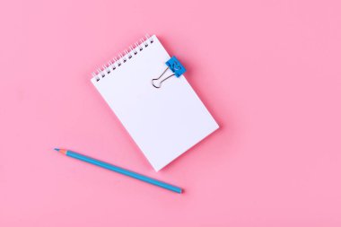 Boş defter peb ile üstten görünüm kopya alanı ile pembe renkli arka plan üzerinde.