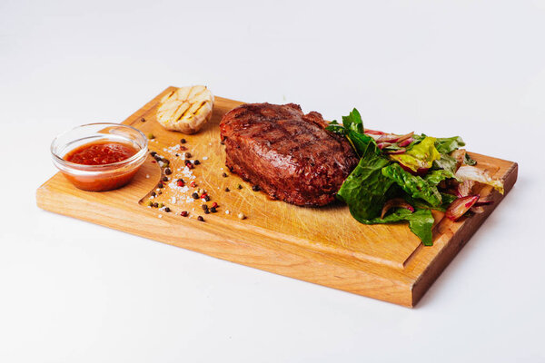 grilled beef steak and potatoes isolated on white background, top view