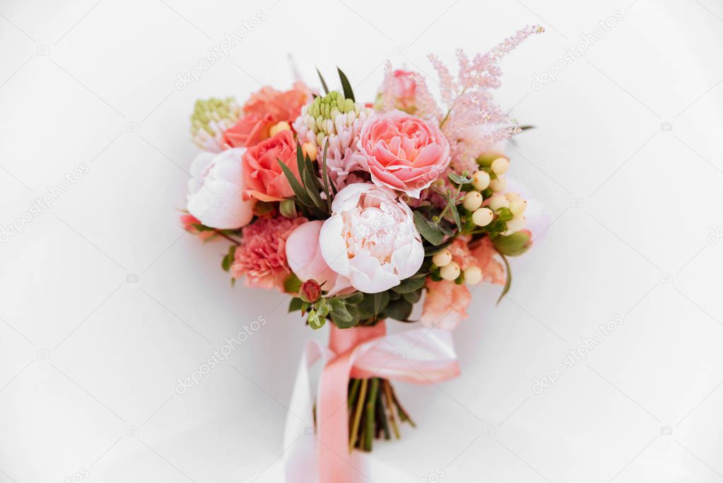 Wedding flowers, bridal bouquet closeup. Decoration made of roses, peonies and decorative plants, close-up, white background