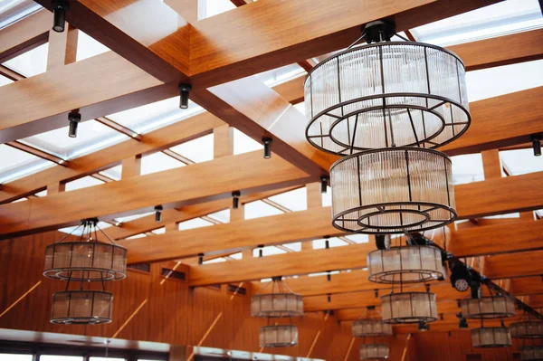 interior of restaurant with big lamps in golden light