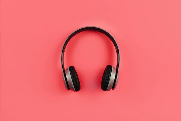 Fashionable headphones on colour background. Music concept.