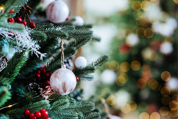 Decorated Christmas tree on blurred, sparkling and fairy background