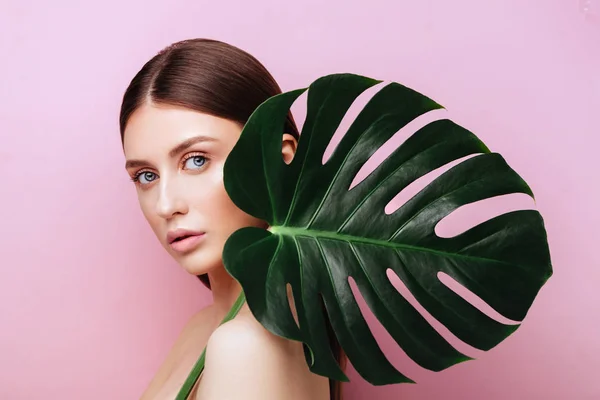 Beauty Woman with natural green palm leaf Portrait