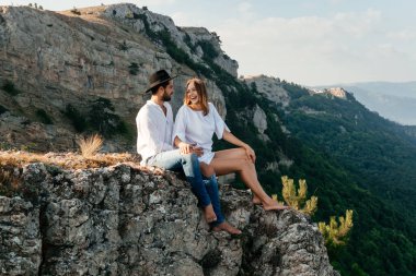 Yeşil dağ manzarasında çekici, genç, sevgi dolu bir çift.