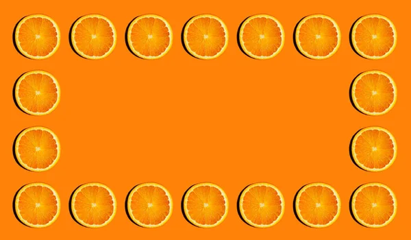Frame of sliced bright oranges on bright orange background