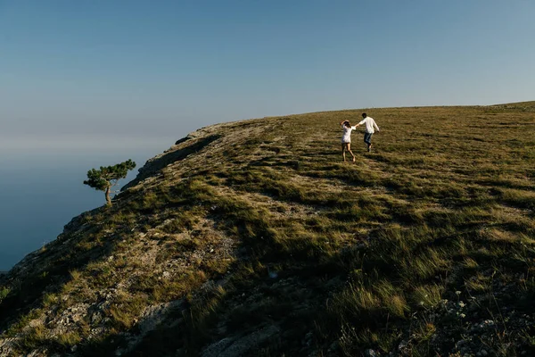 Atraente jovem casal amoroso de homem e mulher na paisagem de montanha verde — Fotografia de Stock