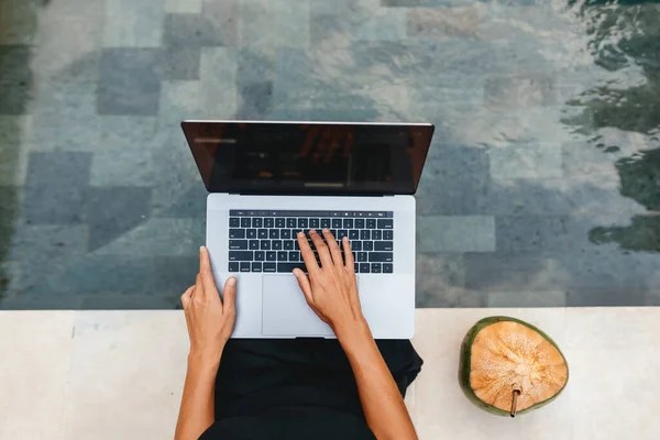 Donna lavoro freelance digitando sul computer portatile con cocco fresco . — Foto Stock