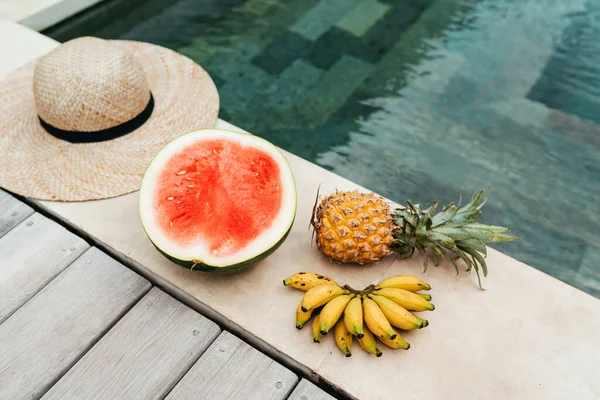 watermelon, pineapple, banana, hat by the pool