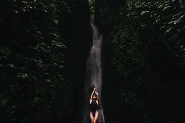 Young girl taking bath in a waterfall — Stock Photo, Image