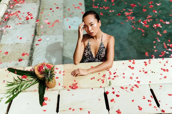 Beautiful female in swimming pool background — Stock Photo, Image
