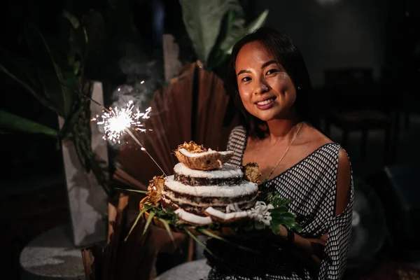 Portrait of charming girl blowing on candles on birthday cake — Stock Photo, Image