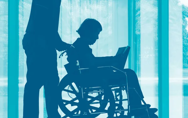 Elderly Woman Reading Book Wheelchair Her Son Take Care — Stock Photo, Image