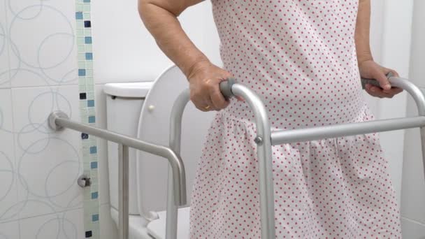 Elderly Woman Holding Walker Toilet — Stock Video