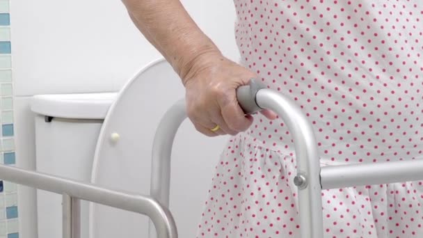 Elderly Woman Holding Walker Toilet — Stock Video