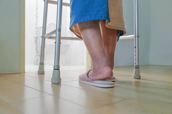 Elderly swollen feet or edema leg walk into bathroom — Stock Photo, Image