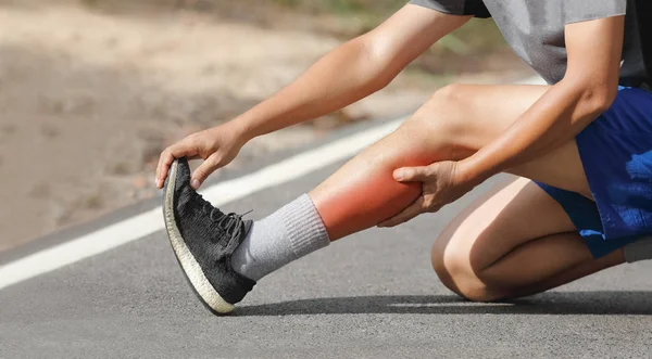 Male middle aged having a cramp while jogging. Stop and massage calf — Stock Image Male middle aged having a cramp while jogging. Stop and massage calf Stock Image
