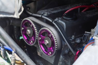 Timing belt and twin camshaft sprocket in engine racing car. clipart