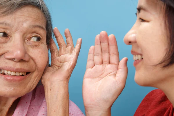 Asian seniors woman hearing loss , Hard of hearing try to talk with daughter.