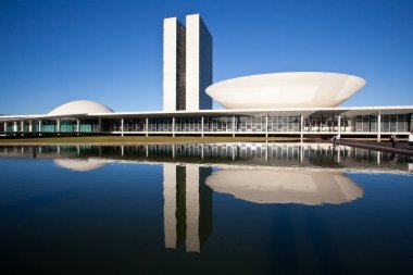 The National Congress of Brazil designed by Brazilian architect Oscar Niemeyer.  The left hemisphere is the Senate and the right the Chamber of Deputies.  Brasilia, DF, Brazil, South America. clipart
