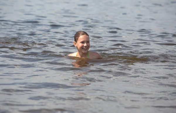 little beautiful girl swimming in the river