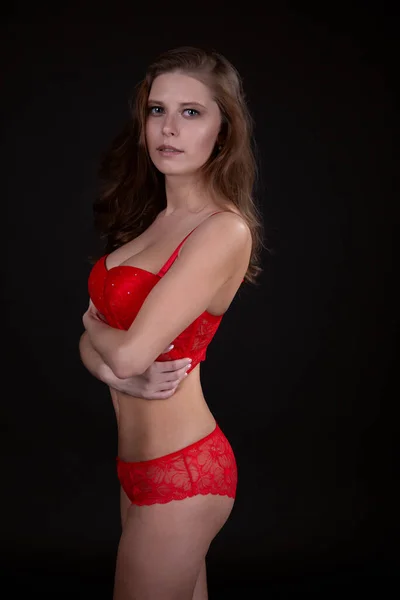 Ελκυστική σέξι γυναίκα με όμορφο σώμα που ποζάρει με δαντελωτά κόκκινα εσώρουχα — Φωτογραφία Αρχείου