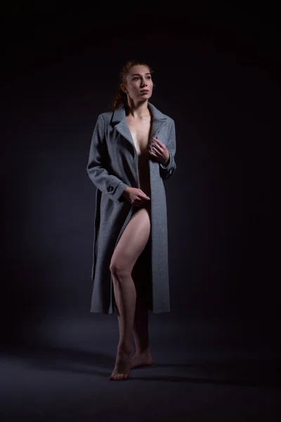 Portrait of a Nude seductive woman in an elegant coat — Stock Photo, Image