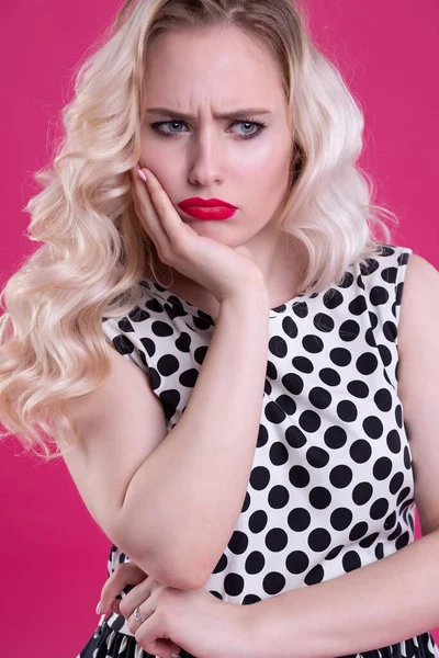 A close up portrait of a young blonde woman with a stern displeased look full of annoyance and a furrowed brow — Stock Photo, Image