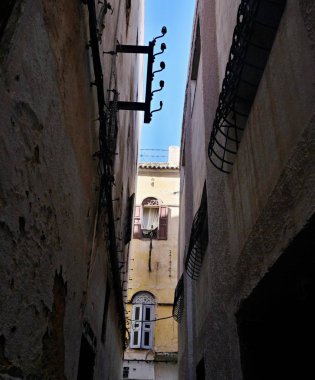 Farklı renklerde boyanmış ve kötü durumda evlerin duvarları ile dar şeritli