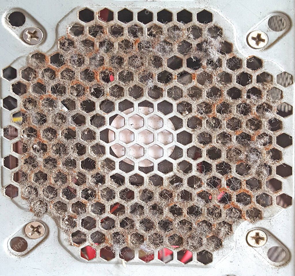 Old computer ventilation grill filled with dust and dirt