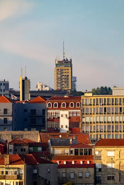 Various buildings are lit by the late afternoon sun in Porto.