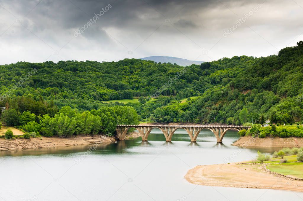lush green hills and bridge over river water