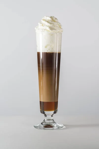 big glass of coffee drink with whipped cream