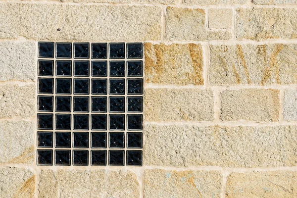 grid window on sun lighted building facade