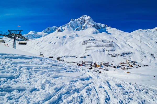 mountainous village with small houses in snowcapped scene