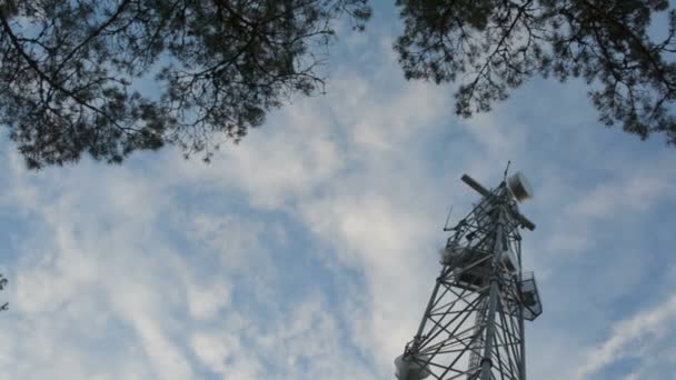 Rotating dish radar on very tall mobile connection cell tower viewed from below — Stock Video