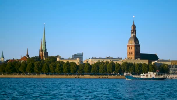 Riga City Old Town panorama with ship passing by on Daugava river at sunset — Stock Video