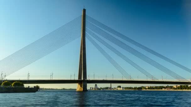 Timelapse of traffic on cable bridge in Riga with people canoeing nearby — Stock Video