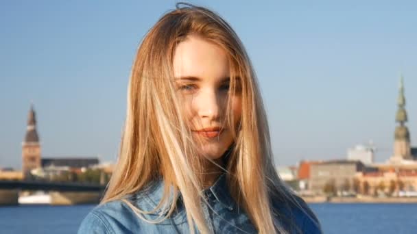 Portrait of a beautiful blond lady in summer sunset with Riga city panorama on the background — Wideo stockowe