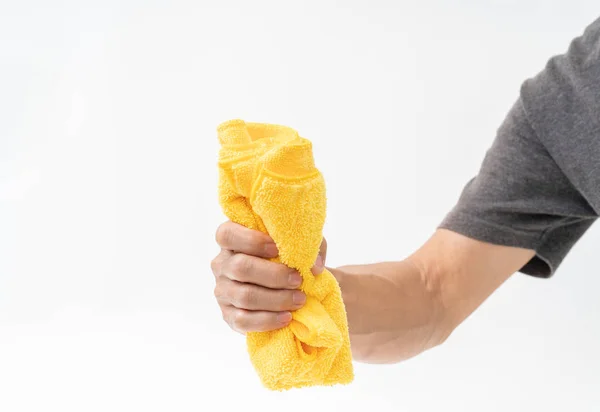Man hand holding yellow rag on white background — Stock Photo, Image