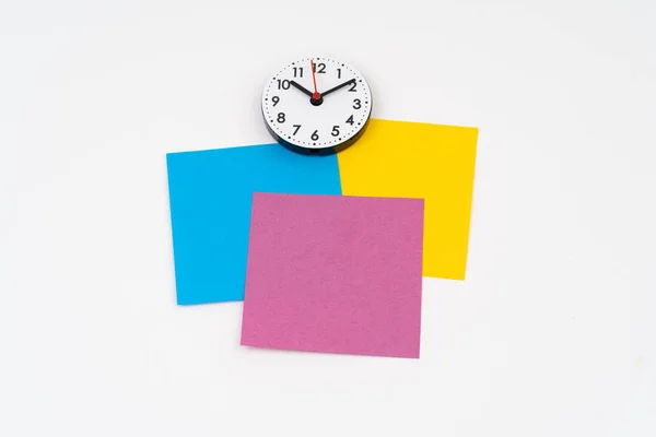 Blank colorful post-it with clock time at ten minute past ten