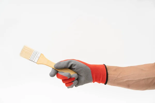 Man hand met rode antislip handschoen houden verfborstel — Stockfoto