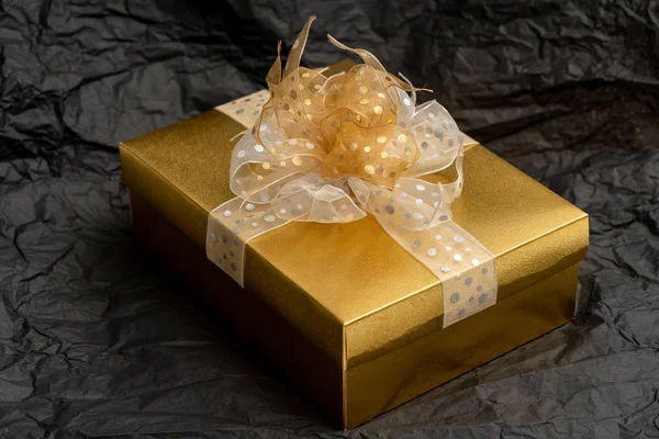 Gold gift box on black background — Stock Photo, Image