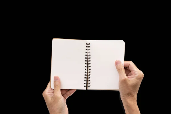 Homem mão segurando notebook em branco no fundo preto — Fotografia de Stock