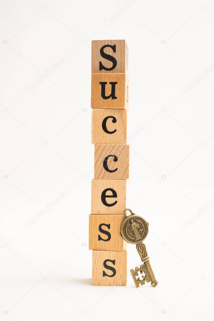 Wood block success word with key on white background. for busine