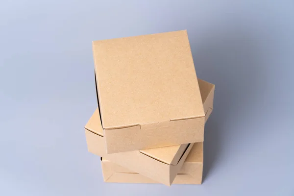 Brown paper box for food package. carton on a gray background.