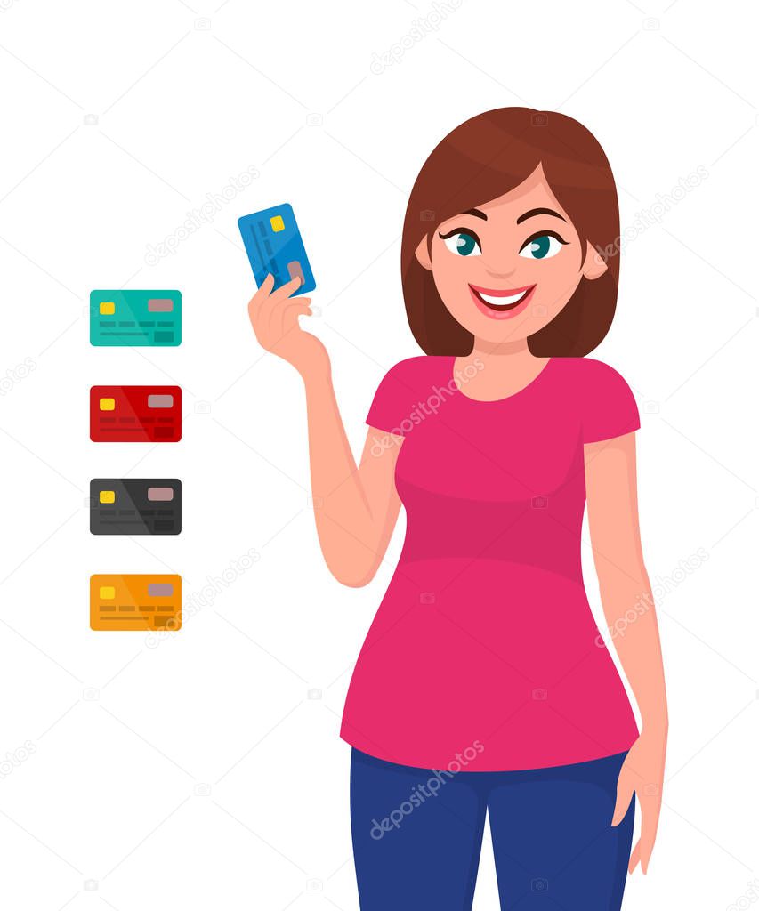 Young woman holding and showing credit card or debit cart. Banking and payment concept.