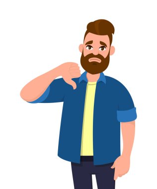 Başparmak aşağı işareti jest gösterilen mutsuz genç adam. Sevmediğim, katılmıyorum, hayal kırıklığı, reddetme, hiçbir anlaşma kavramı.