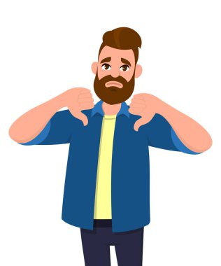 Başparmak aşağı işareti jest gösterilen mutsuz genç adam. Sevmediğim, katılmıyorum, hayal kırıklığı, reddetme, hiçbir anlaşma kavramı.