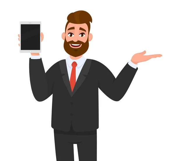 Happy young business man showing/holding blank screen of tablet computer display and presenting/ introducing/pointing something to copy space side away with hand gesture.  Modern digital technology. — Stock Vector